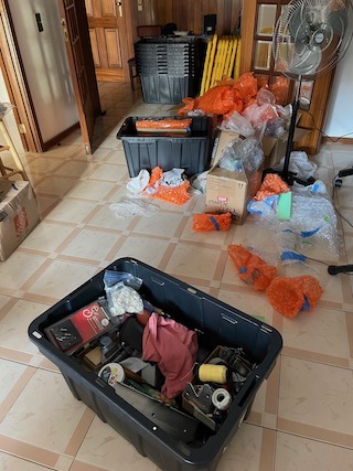 A messy living room filled with packing materials.