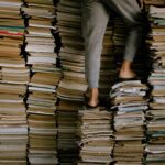 person standing on stacks of books